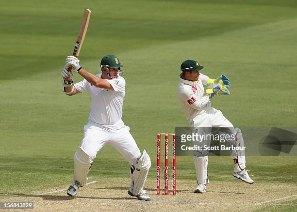 Graeme Smith of South Africa hits a boundary as Matthew Wade of Australia looks on during day two of the Second Test match between Australia and...