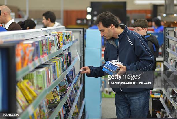 Shopper looks through DVDs inside of a Best Buy store during their Black Friday sale which started at midnight on November 23, 2012 in Rockville,...