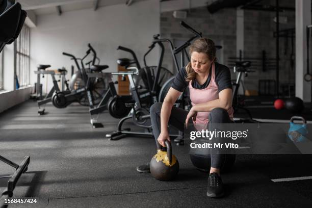 woman exercising in a gym with kettle - kettle stock pictures, royalty-free photos & images