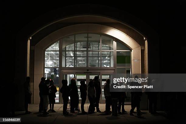 Shoppers wait to enter a Best Buy store on November 22, 2012 in Naples, Florida. Although controversial, many big retail stores have again decided to...