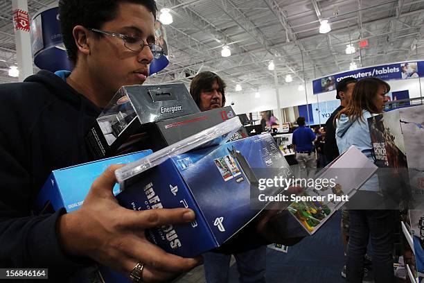 Shoppers move through a Best Buy store on November 23, 2012 in Naples, Florida. Although controversial, many big retail stores have again decided to...