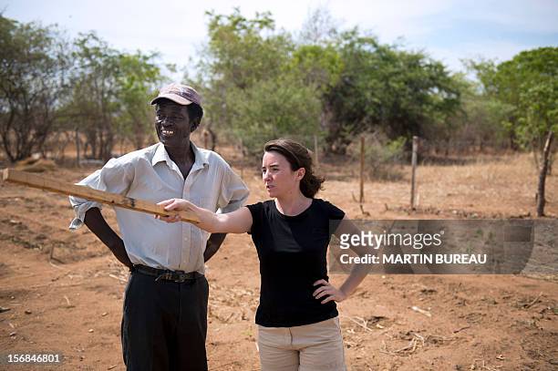 French CNRS researcher Chloe Guerbois talks to Victor Bitu , the owner of a field destroyed by elephants, on November 19, 2012 in the village of...