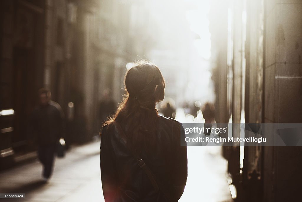 Girl walking down misty street