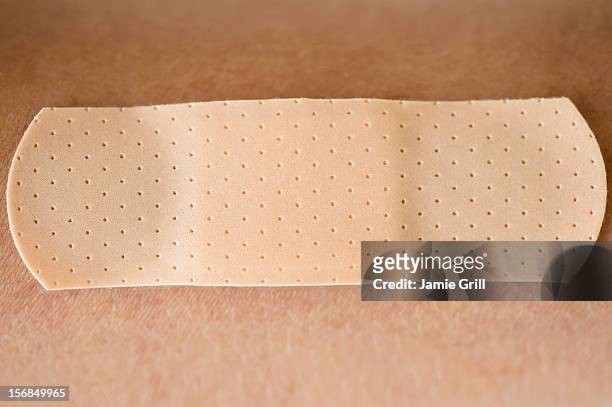 studio shot of adhesive bandage - band aid fotografías e imágenes de stock