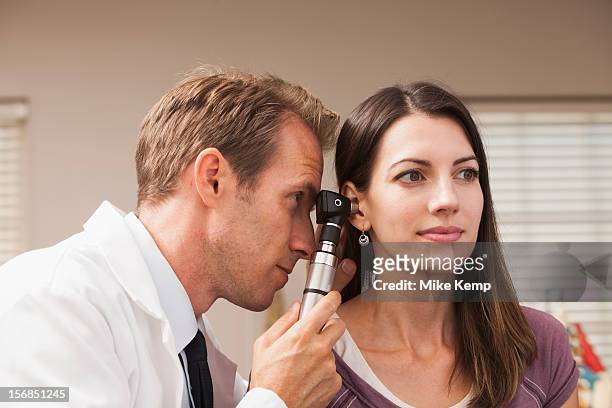 usa, utah, orem, doctor performing hearing test with otoscope - otoscope bildbanksfoton och bilder