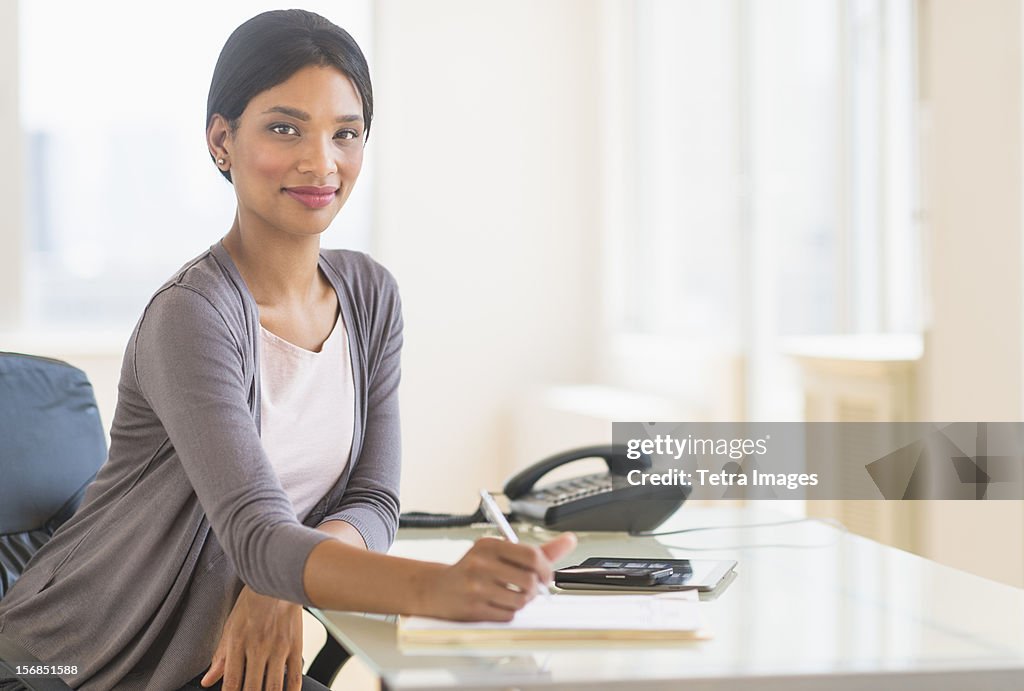 USA, New Jersey, Jersey City, Portrait of businesswoman in office