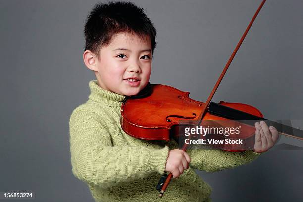 boy playing violin - children holding musical instruments stock pictures, royalty-free photos & images