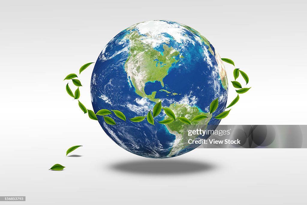 Digital composite of earth and greenn leaf