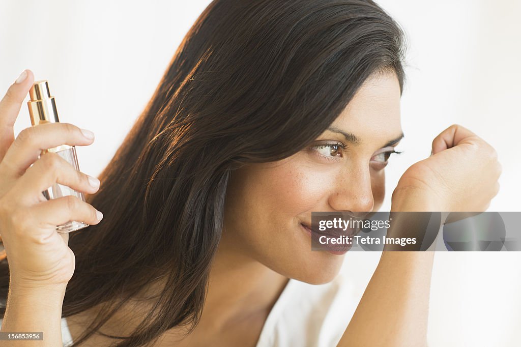 USA, New Jersey, Jersey City, Woman smelling perfume on wrist