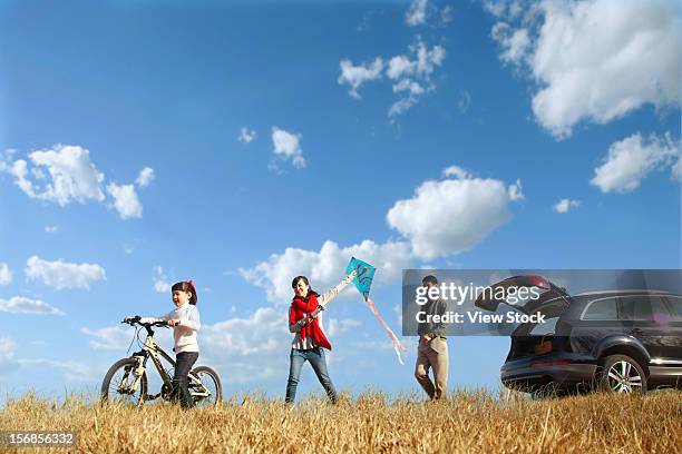 family in autumn - walking side view stock-fotos und bilder