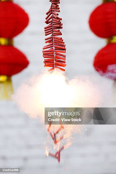 burning firecrackers and red lanterns - petard stock pictures, royalty-free photos & images