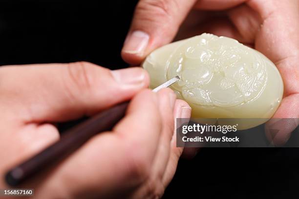 an artisan carves jade - jade stock pictures, royalty-free photos & images