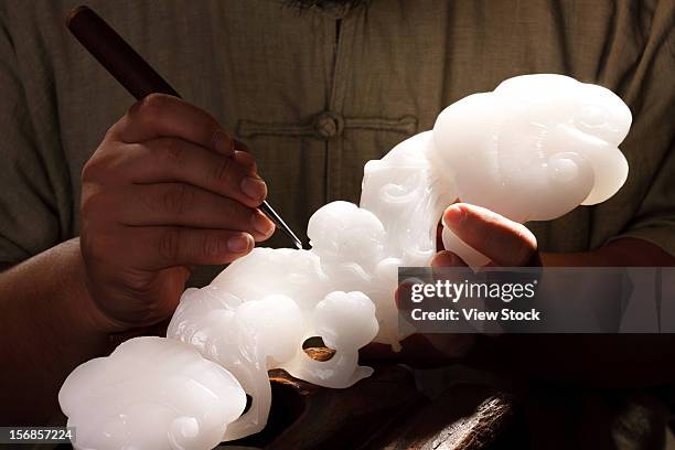 an artisan carves jade - jade gema imagens e fotografias de stock