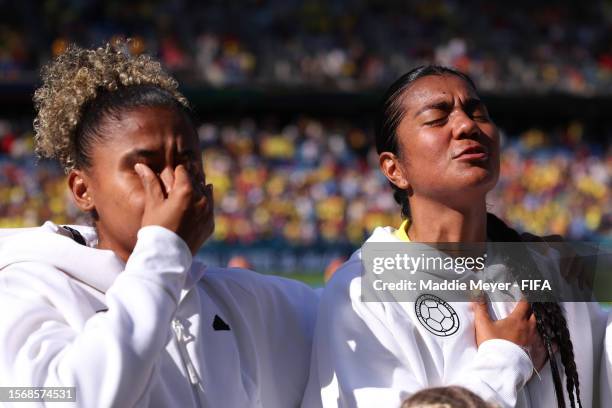 Jorelyn Carabali and Daniela Arias of Colombia show emotion as they sing the national anthem prior to the FIFA Women's World Cup Australia & New...