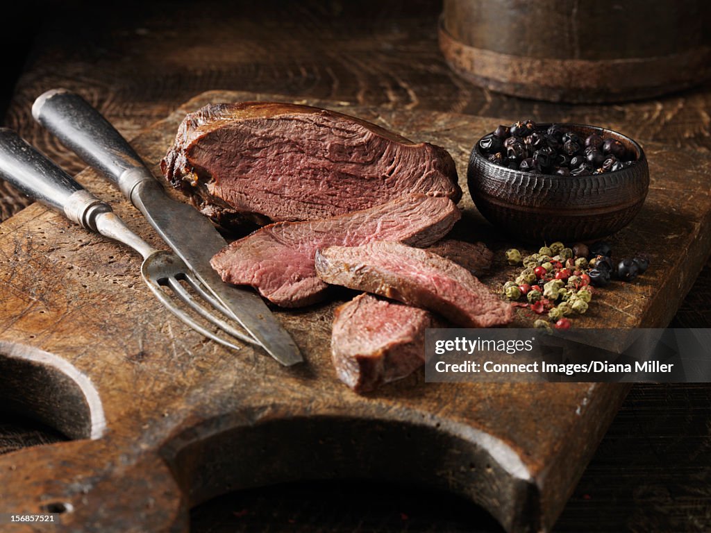 Sliced venison and juniper berries