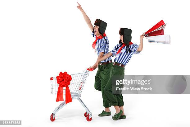 young couple with shopping cart - decades for modern vintage shoe collaboration stock-fotos und bilder