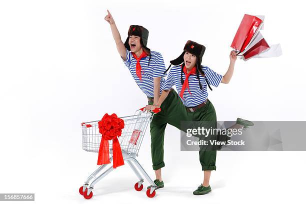 young couple with shopping cart - decades for modern vintage shoe collaboration stock-fotos und bilder