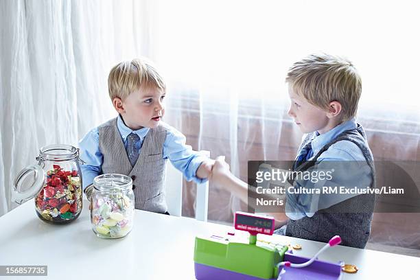 boys playing with cash register - deal england stock-fotos und bilder