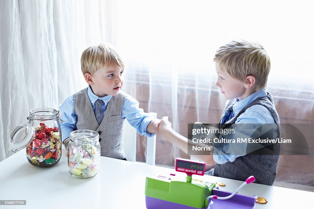 Boys playing with cash register