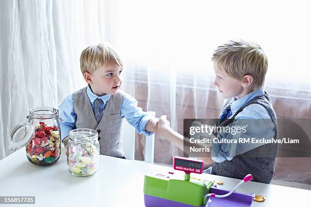 boys playing with cash register - deal england stock pictures, royalty-free photos & images