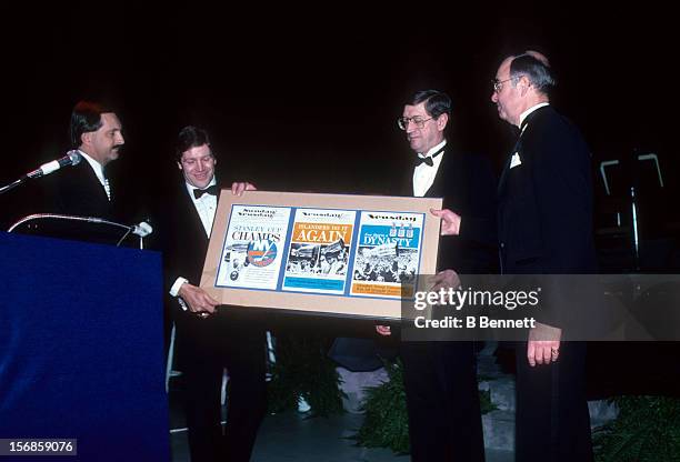 Denis Potvin, head coach Al Arbour and general manager Bill Torrey accept an award during the 1983 NHL All Star dinner on February 7, 1983 in...