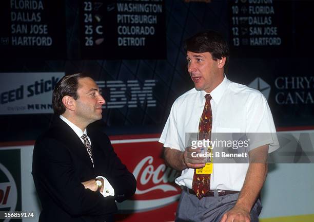 Commissioner Gary Bettman speaks with general manager Mike Milbury of the New York Islanders before the 1995 NHL Draft on July 8, 1995 at the...