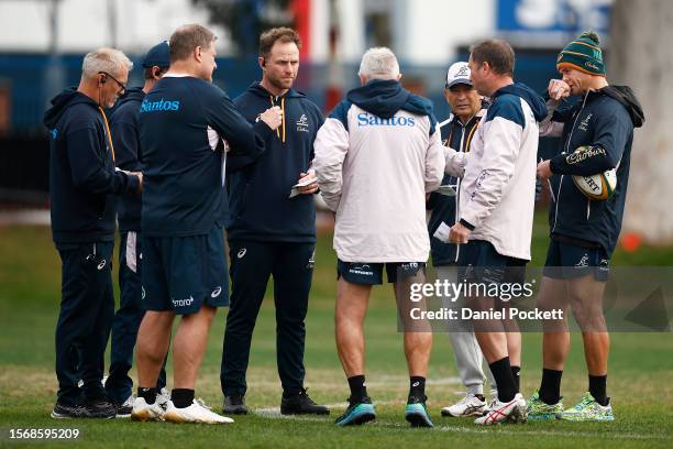 Wallabies head coach Eddie Jones chats with his coaching team during an Australia Wallabies training session at Brighton Grammar School on July 25,...