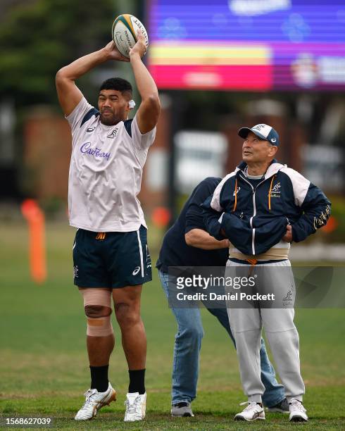 Wallabies head coach Eddie Jones watches on as Jordan Uelese of the Wallabies throws the ball during an Australia Wallabies training session at...
