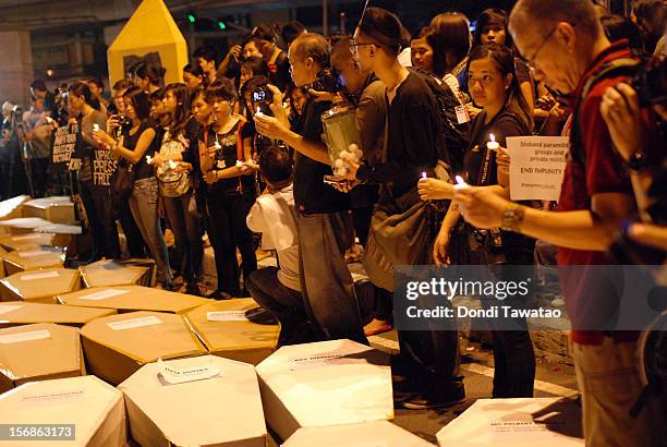 Filipino journalists and journalism students light candles in prayer during the Remembrance Day Rally commemorating the 34 journalists massacred by...