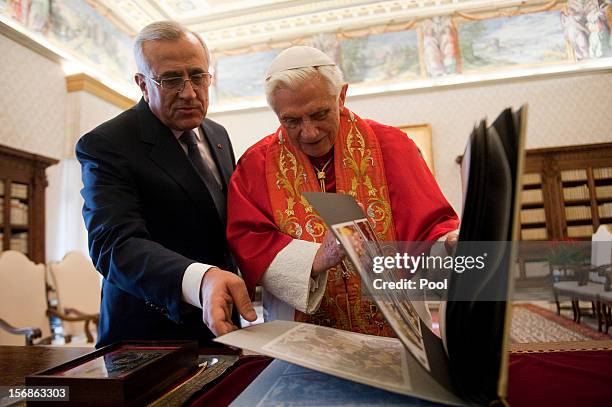 Pope Benedict XVI exchanges gifts with Lebanon President Michel Sleiman during a meeting at his private library on November 23, 2012 in Vatican City,...