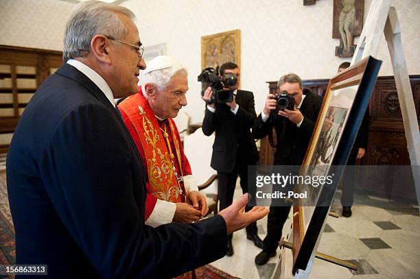 Pope Benedict XVI exchanges gifts with Lebanon President Michel Sleiman during a meeting at his private library on November 23, 2012 in Vatican City,...