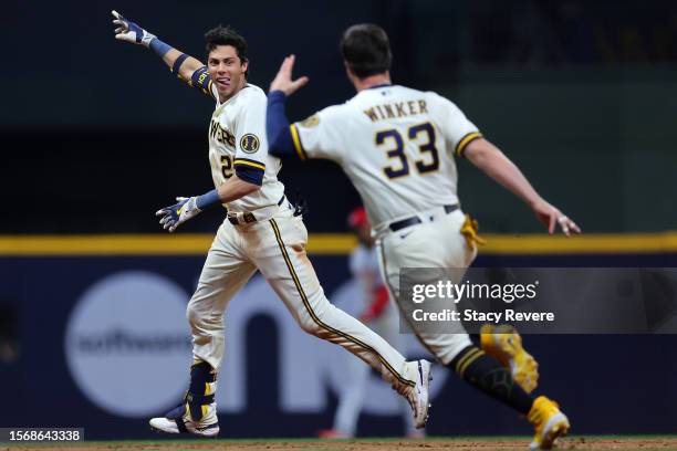 Christian Yelich of the Milwaukee Brewers celebrates a walk off RBI single with Jesse Winker to defeat the Cincinnati Reds during the ninth inning at...