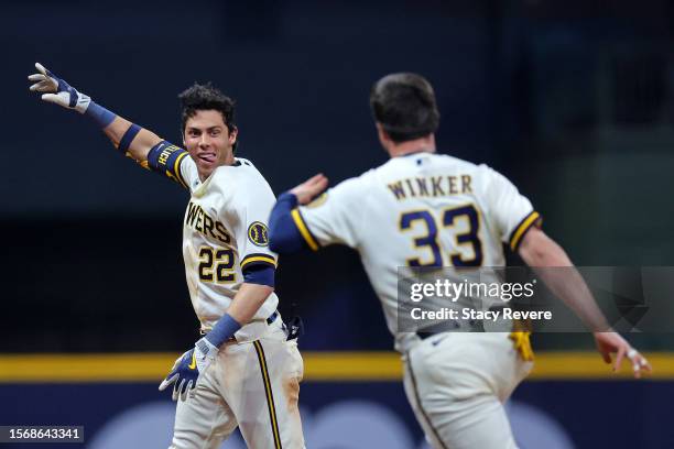 Christian Yelich of the Milwaukee Brewers celebrates a walk off RBI single with Jesse Winker to defeat the Cincinnati Reds during the ninth inning at...