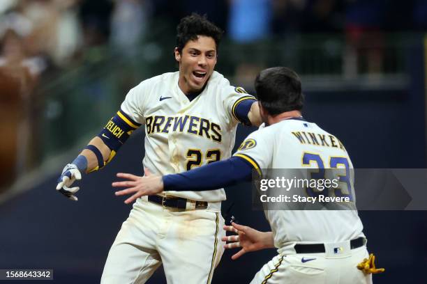 Christian Yelich of the Milwaukee Brewers celebrates a walk off RBI single with Jesse Winker to defeat the Cincinnati Reds during the ninth inning at...