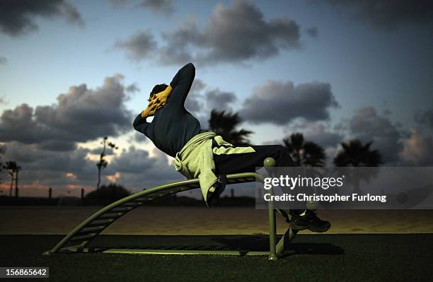 Woman exercises near the beach in the southern Israeli town of Ashkelon on November 23, 2012 in Ashkelon, Israel. Daily life in the southern border...