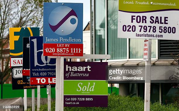 Estate agent signs advertising residential property ''To Let'', ''Let By'', "For Sale", and ''Sold'' are seen in the Wandsworth district of London,...