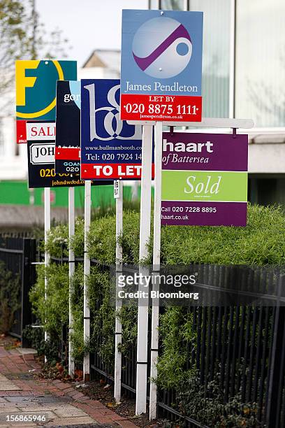 Estate agent signs advertising residential property ''To Let'', ''Let By'', "For Sale", and ''Sold'' are seen in the Wandsworth district of London,...