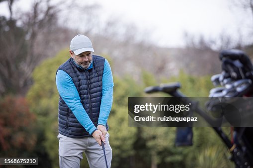 Adult man playing golf in autumn Adult man playing golf in autumn