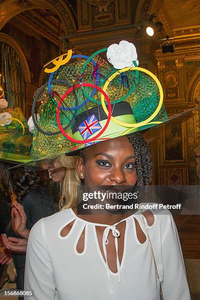 Young employee of the Chanel fashion house poses prior to parading at the Paris City Hall during the Sainte-Catherine Celebration on November 23,...