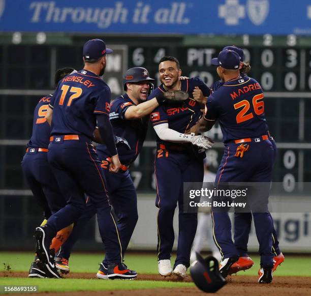 Yainer Diaz of the Houston Astros celebrates with his teammates after singling in the winning run in the ninth inning against the Texas Rangers at...