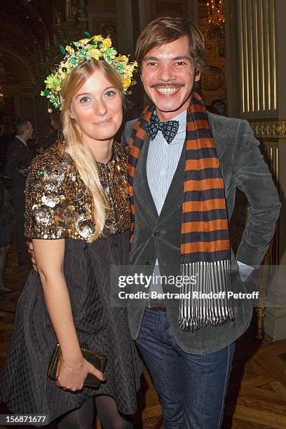 Elie Top , Lanvin fashion house's jewelry designer, and a young Lanvin employee pose at the Paris City Hall during the Sainte-Catherine Celebration...