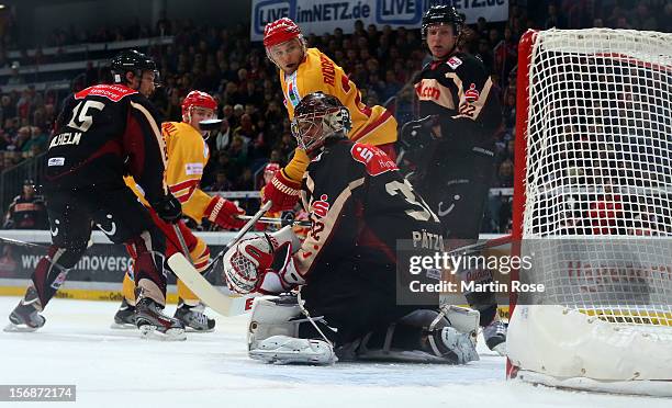 Dimitri Paetzold , goaltender of Hannover makes a save on Carl Ridderwall of Duesseldorf during the DEL match between Hannover Scorpions and...