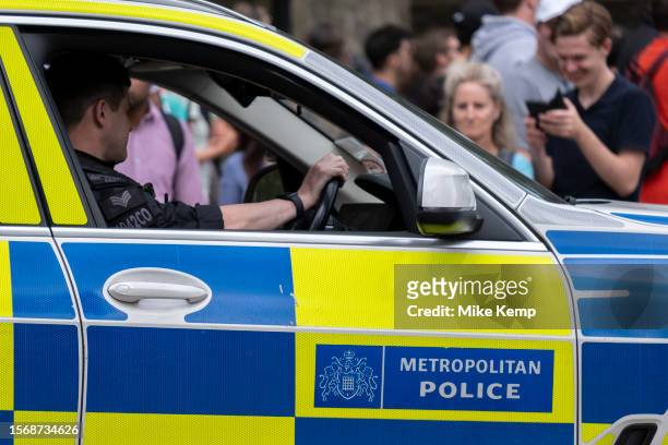 Metropolitan Police vehicle and officers on patrol outside on 10th July 2023 in London, United Kingdom. The Metropolitan Police Service, formerly and...