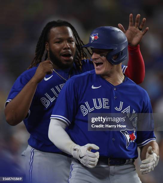 Matt Chapman of the Toronto Blue Jays celebrates his solo homerun with Vladimir Guerrero Jr. #27, to take a 3-2 lead over the Los Angeles Dodgers,...