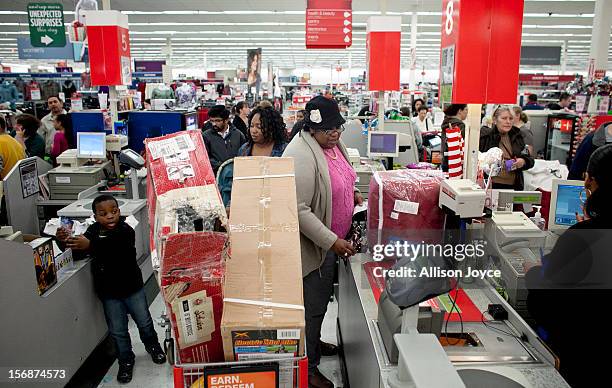 Shoppers wait in a check out line at Kmart during the Black Friday sales on November 23, 2012 in Braintree, Massachusetts. Black Friday, the start of...