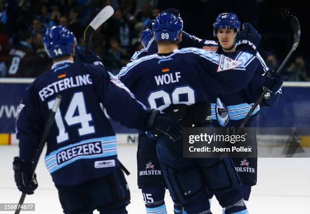 Jerome Flaake of Hamburg celebrates with his team mates after scoring his team's first goal during the DEL match between Hamburg Freezers and...