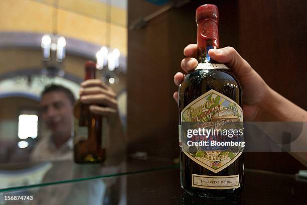 Bartender displays a bottle of Jose Cuervo Reserva de la Familia for a photograph at the Tequila Cuervo La Rojena S.A. De C.V. Distillery plant in...