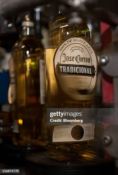 Machine adds the label to a bottle of Jose Cuervo Tradicional on the production line at the Tequila Cuervo La Rojena S.A. De C.V. Bottling factory in...