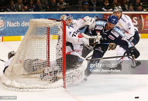 Garret Festerling of Hamburg competes for the puck with Robert Zepp of Berlin during the DEL match between Hamburg Freezers and Eisbaeren Berlin at...