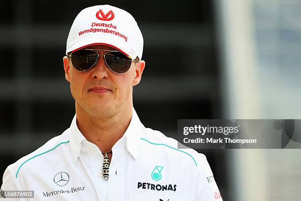Michael Schumacher of Germany and Mercedes GP walks in the paddock following practice for the Brazilian Formula One Grand Prix at the Autodromo Jose...